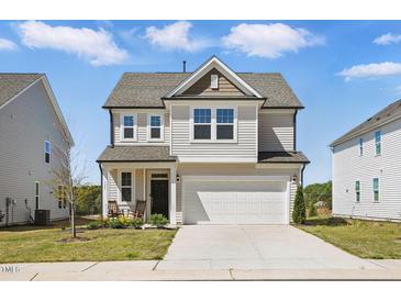 Charming two-story home featuring a two-car garage, covered entry, and well-maintained landscaping at 135 Carlton Ln, Franklinton, NC 27525