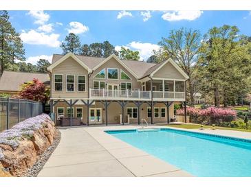 Stunning two-story home with a spacious deck overlooking a private backyard and inviting swimming pool at 1422 Gormly Cir, Sanford, NC 27330