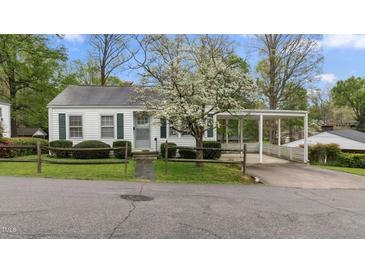Charming one-story home with a quaint wooden fence and a covered carport for convenient parking at 1631 Sunset Ave, Henderson, NC 27536
