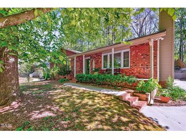 Charming brick home featuring a well-manicured lawn and inviting front entrance at 201 Dunhagan Pl, Cary, NC 27511