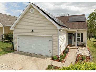 Charming home featuring a two-car garage, solar panels, and a welcoming front entrance at 2124 Castle Pines Dr, Raleigh, NC 27604