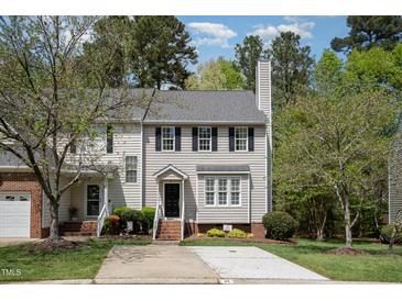 Charming two-story townhouse with neutral siding, black shutters, and a well-manicured front lawn at 22 Lure Ct, Durham, NC 27713