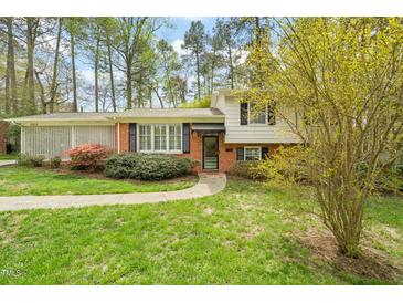Charming two-story home with brick and vinyl siding and a well-maintained, landscaped front yard at 2415 Alpine Rd, Durham, NC 27707