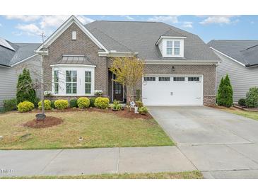 Charming brick home with well-maintained landscaping and a two-car garage in a beautiful neighborhood at 2832 Thompson Bluff Dr, Cary, NC 27519