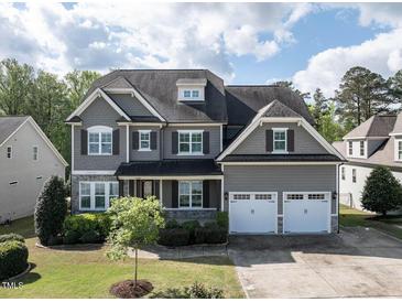 Charming two-story home features a well-manicured lawn, attached two-car garage, and lovely curb appeal at 2905 Pluton Pl, Rolesville, NC 27571