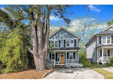 Charming two-story home with a welcoming porch and a bright yellow front door at 3 Maple St, Raleigh, NC 27610