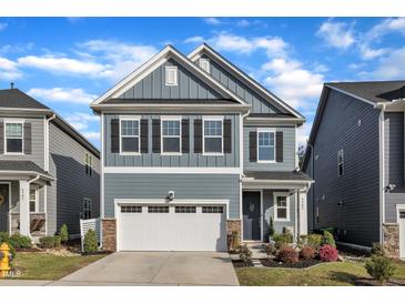 Charming two-story home with blue siding, stone accents, and a two-car garage in a well-kept neighborhood at 4905 Abundance Ave, Raleigh, NC 27616