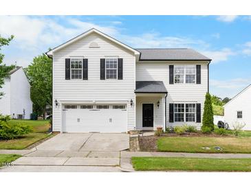 Charming two-story home with a well-maintained lawn, two-car garage, and classic black and white color scheme at 6102 Coronado Ln, Durham, NC 27713