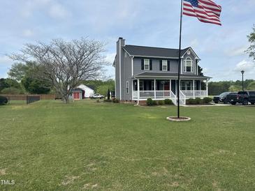 Charming two-story home with a spacious front yard and a welcoming front porch at 1020 Retriever Ln, Raleigh, NC 27603