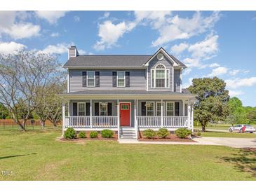 Charming two-story home features a spacious front porch, well-manicured lawn, and classic architectural details at 1020 Retriever Ln, Raleigh, NC 27603