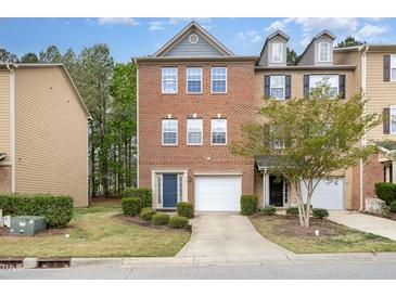 Charming two-story brick townhome features a garage and a blue front door at 117 Gallent Hedge Trl, Apex, NC 27539