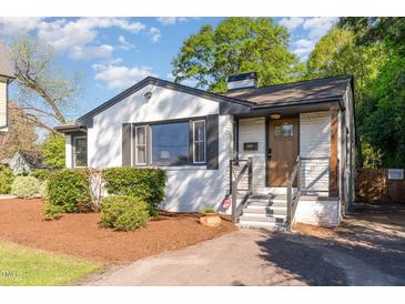 Charming brick home with a well-manicured lawn, black shutters and painted brickwork providing timeless curb appeal at 206 Bickett Blvd, Raleigh, NC 27608