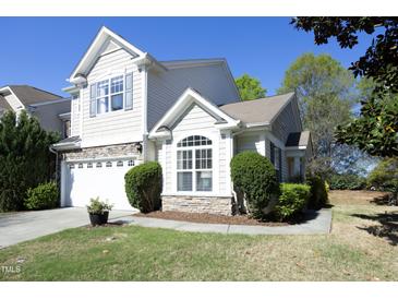 Beautiful two-story home featuring stone accents, a manicured lawn, and an attached two car garage at 409 Courthouse Dr, Morrisville, NC 27560