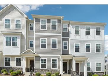 New townhome exterior showcasing a craftsman style with varied siding textures and stone accents at 5217 Invention Way, Raleigh, NC 27616