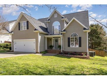 Charming two-story home featuring a well-manicured lawn, attached garage, and inviting front entrance at 756 Rockville Rd, Wake Forest, NC 27587