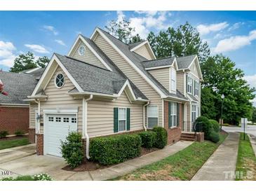 Charming home featuring a one-car garage, brick accents, a manicured lawn, and a traditional design at 9531 Vira Dr, Raleigh, NC 27617