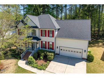 Beautiful two-story home featuring a well-manicured front yard and attached two-car garage at 103 Caymus Ct, Cary, NC 27519