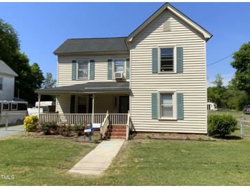 Charming two-story home featuring a well-maintained lawn, inviting front porch and traditional architectural details at 104 N 16Th St, Erwin, NC 28339