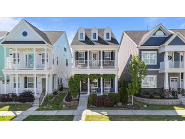Charming two-story home with double porches, white columns, and well-maintained landscaping at 1126 Russet Ln, Apex, NC 27523