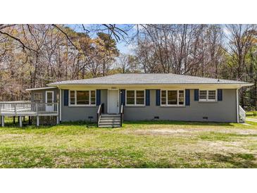 Charming single-story house featuring blue shutters and a well-maintained front yard at 13832 Nc 96 N Hwy, Zebulon, NC 27597
