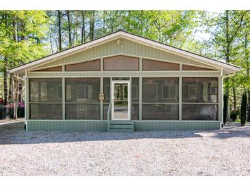 Charming home featuring a screened-in porch and gravel landscaping for low maintenance at 142 Blackhawk Dr, Louisburg, NC 27549