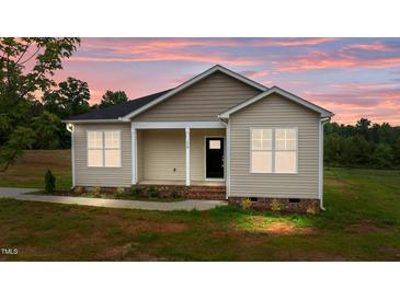Charming one-story home featuring neutral siding, black front door and a cozy covered porch at 170 Brookhaven Dr, Spring Hope, NC 27882