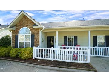 Charming townhouse featuring stone accents, a cozy front porch, and a well-maintained landscape at 201 Blithe Pl, Morrisville, NC 27560