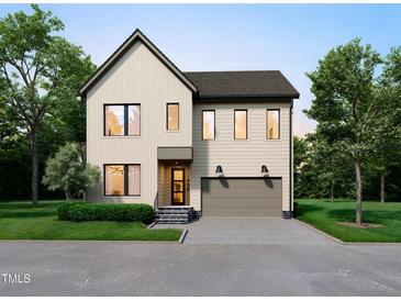 Charming two-story home featuring a neutral color palette, a gray roof, and a two-car garage at 406 Columbia Dr, Raleigh, NC 27604