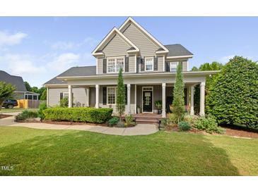 Charming two-story home featuring a welcoming front porch with classic columns and a well-manicured lawn at 4769 Swordfish Dr, Raleigh, NC 27603