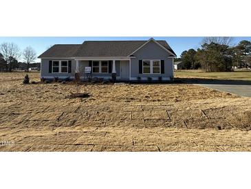 Charming single-story home with a manicured front yard, inviting entrance, and classic architectural details at 48 Pate Landing Dr, Selma, NC 27576