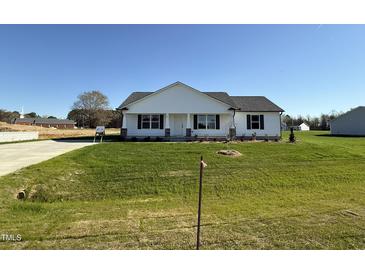 Charming single-story home featuring a well-maintained lawn and traditional architectural details at 99 Pate Landing Dr, Selma, NC 27576