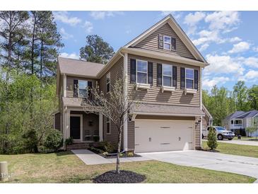 Charming two-story home with a two-car garage and beautifully landscaped front yard at 104 Lowe Wood Ct, Durham, NC 27703