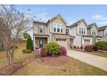 Charming townhouse featuring a well-maintained yard and inviting curb appeal at 1103 Kudzu St, Durham, NC 27713