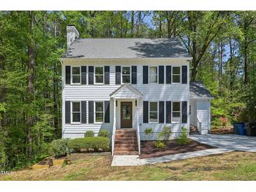 Charming two-story home featuring black shutters, a brick-lined stairway, and a well-maintained front yard at 14 W Bridlewood Trl, Durham, NC 27713