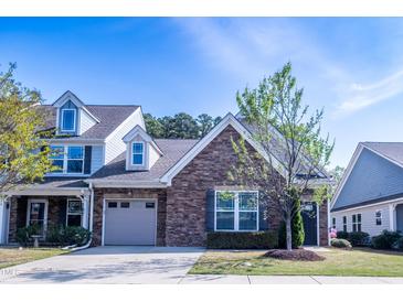 Charming home featuring stone accents, attached garage, and well-maintained landscaping at 150 Red Admiral Ct, Hillsborough, NC 27278