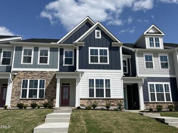Beautiful townhome featuring stone accents, a covered porch, and complementary siding at 1577 Wendell Valley Blvd, Wendell, NC 27591