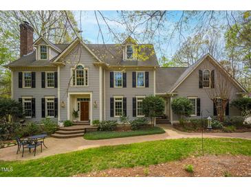 Charming two-story home with manicured lawn, brick walkway, dormer windows and dark shutters at 206 Zapata Ln, Chapel Hill, NC 27517