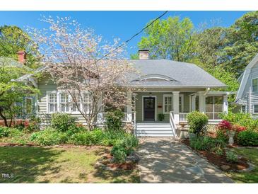 Charming home with a stone pathway, a welcoming front porch, and mature landscaping with a blooming tree at 2416 W Club Blvd, Durham, NC 27705