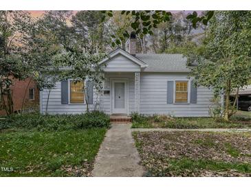 Charming single-story home with a well-maintained lawn and classic architectural details at 312 Greenwood Dr, Durham, NC 27704