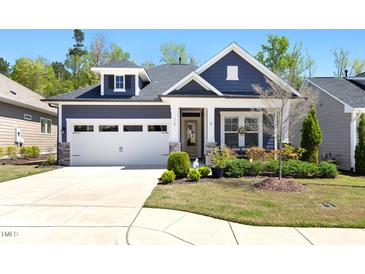 Charming blue two-story home with white trim, a manicured lawn, and an attached two-car garage at 330 Middleton Pl, Chapel Hill, NC 27516