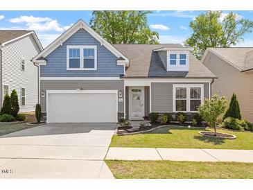 Charming two-story home featuring a two-car garage, manicured lawn, and tasteful landscaping at 356 Avery Glenn Way, Fuquay Varina, NC 27526