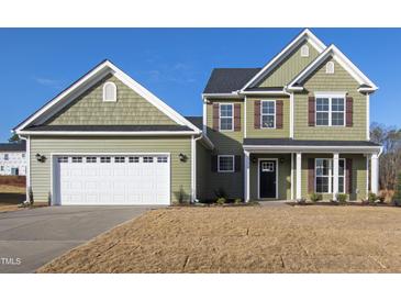Charming two-story home with green siding, attached garage, and a well-maintained front yard at 40 Rosewood Ln, Youngsville, NC 27596