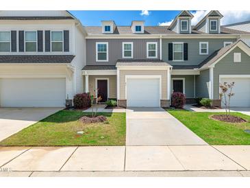 Charming townhomes featuring attached garages, manicured lawns, and varied siding colors for a unique curb appeal at 41 Willow Green Dr, Clayton, NC 27527
