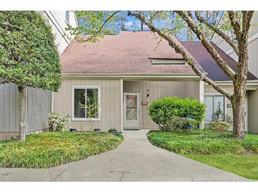 Charming townhome with a well-manicured lawn and inviting walkway to the front door at 4101 Five Oaks Dr # 40, Durham, NC 27707