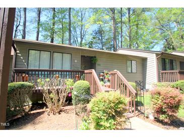 Charming townhouse featuring a cozy porch and mature landscaping at 502 W Poplar Ave # C2, Carrboro, NC 27510