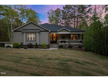 Charming single-story home featuring a covered porch and well-maintained landscaping at 775 Sagamore Dr, Louisburg, NC 27549