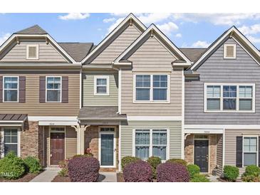 Charming townhome exterior with stone accents and a well-manicured front yard at 7822 Allscott Way, Raleigh, NC 27612