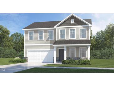 Charming two-story home with stone accents, well-manicured lawn, and attached two-car garage at 87 Glencoe Ln, Zebulon, NC 27597