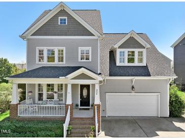Charming two-story home with a covered front porch and attached two-car garage at 904 Coral Bell Dr, Wake Forest, NC 27587