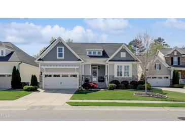 Charming single-Gathering home featuring a landscaped front yard and attached two-car garage at 216 Bella Rose Dr, Chapel Hill, NC 27517